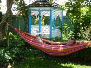 Enjoying the sun in a hammock in the garden.